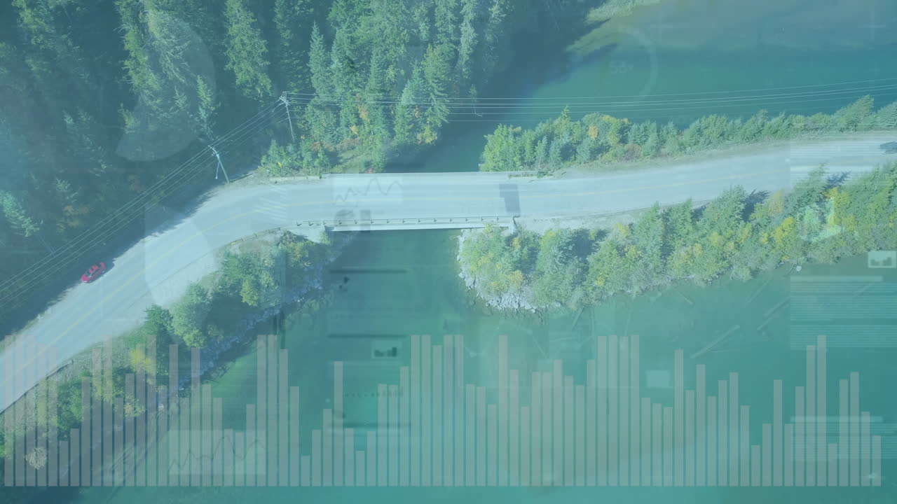 Aerial view of road over water with data processing animation overlay