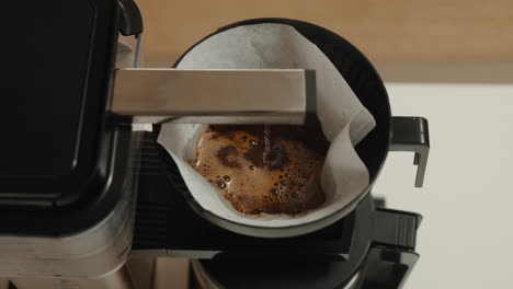 warm coffee brewing in modern drip machine at home