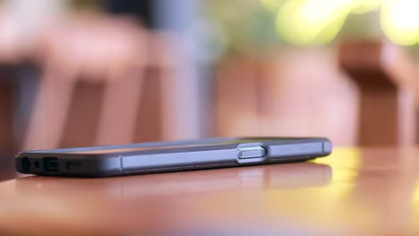 person looking at a phone at a cafe