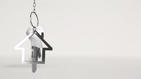 Hausschlüssel-Und-Schlüsselanhänger-Hängen-über-Dem-3D-Hausmodell-Im-Hintergrund