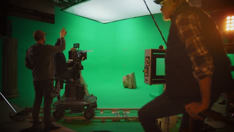 on film studio set director says "cut!", cameraman stops shooting green screen scene with two talented actors wearing renaissance clothes talking. finishing period costume drama movie