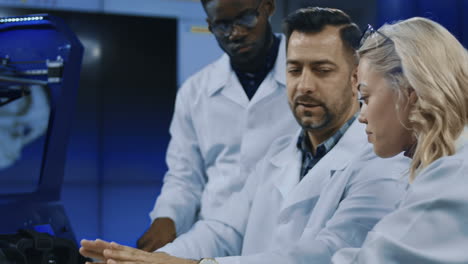 scientists examining 3d printed object in laboratory