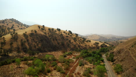 Flying-over-a-dry-riverbed-and-canyon-in-Southern-California-during-a-drought-year-and-wildfire-warning