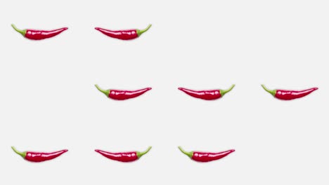 4k 60 fps loop video of chili peppers popping up and flipping.