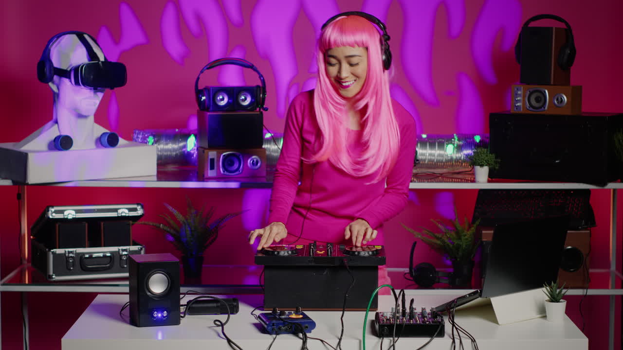 Woman DJ mixing music with pink wig and headphones