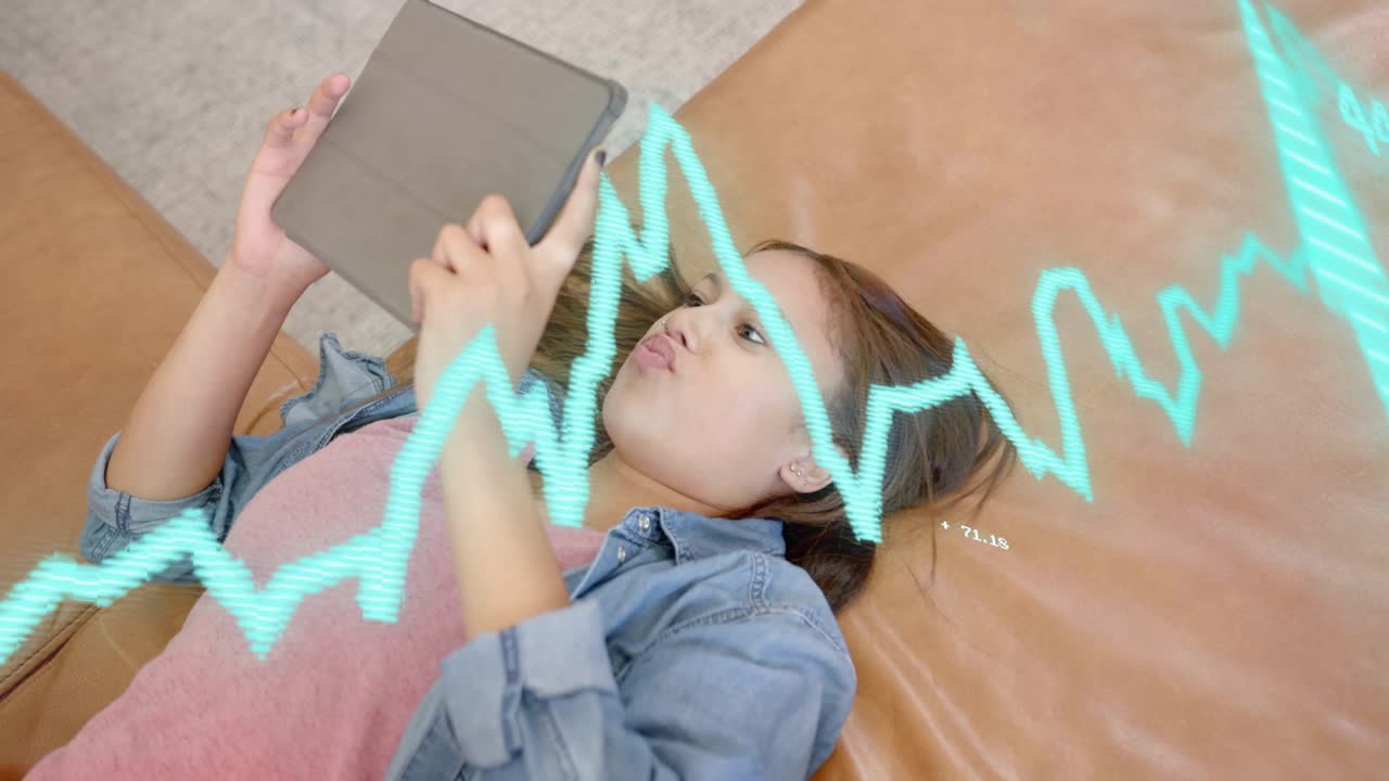 Female student reclining couch tapping, swiping tablet, starting cyan waveform, analyzing tech data