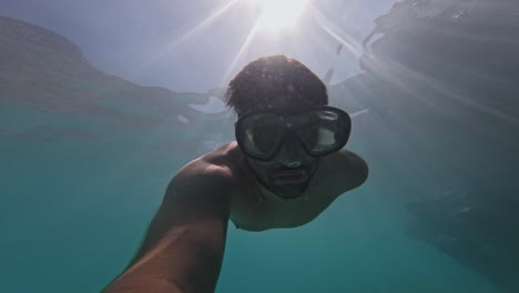 pov of a man snorkeling undersea in summertime