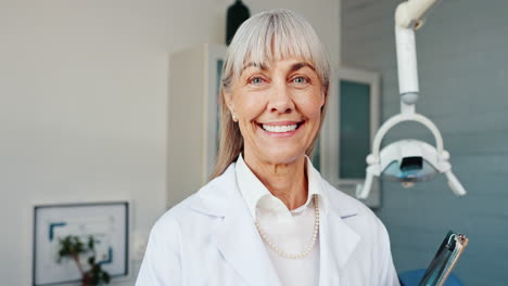 portrait of a smiling dentist in her office