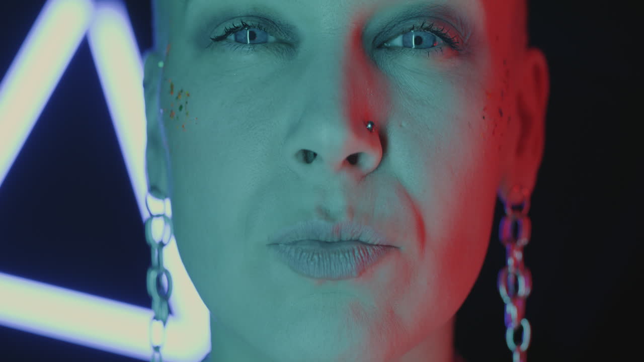 Close-up Portrait of a Woman with Bold Makeup and Neon Lighting