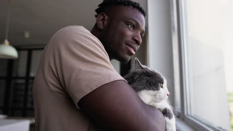 Pet-owner-with-his-cat-at-home