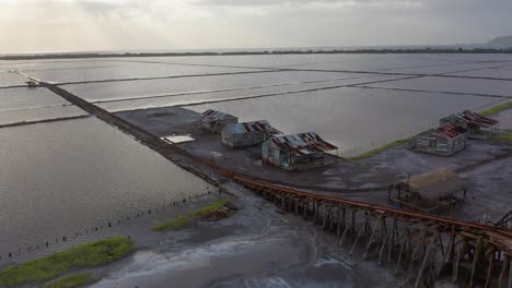 Shot-at-a-low-altitude-in-a-salt-mine,-view-of-train-rails-and-old-houses-that-serve-as-mineral-storage