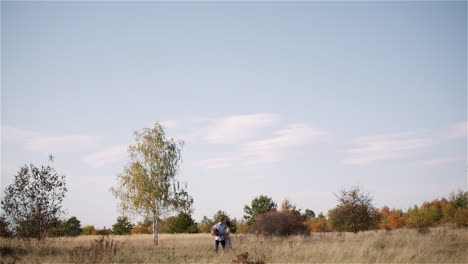 Couple-Hugging-And-Walking-On-A-Meadow-In-Summer-At-Sunset-39