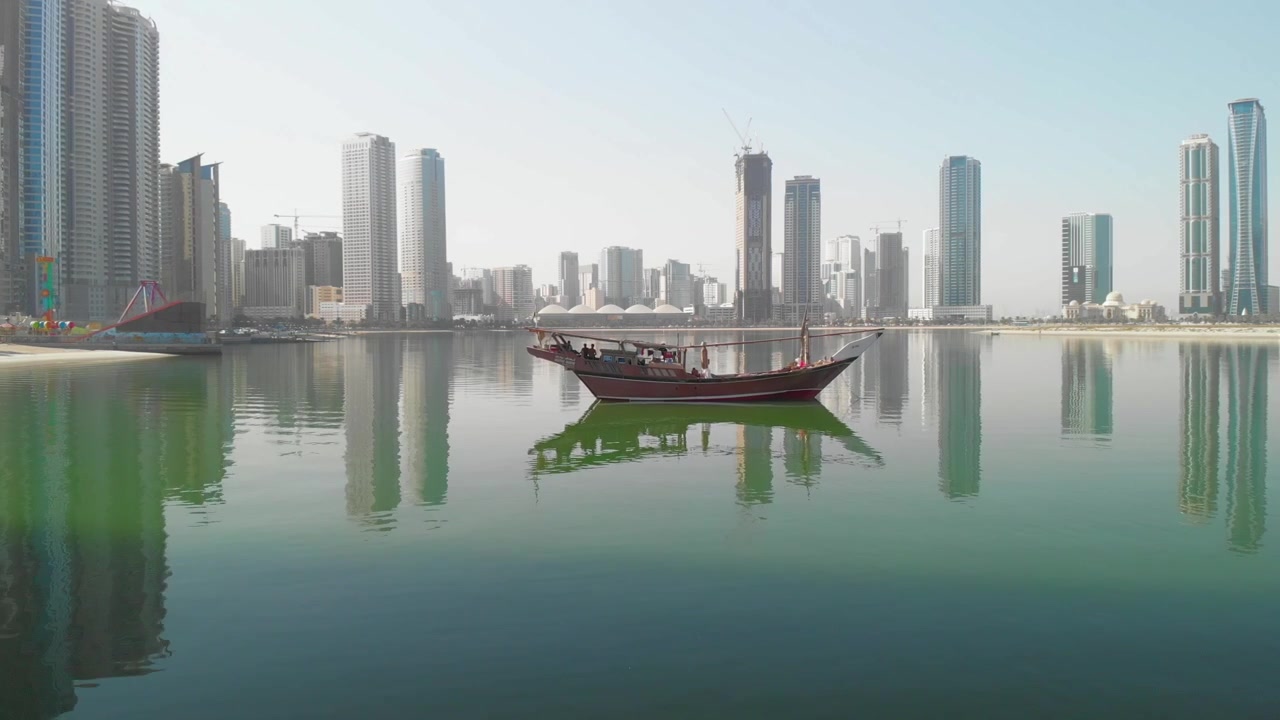 Drone Camera: Traditional Arabian wooden Fishermen Dhow, moored at the Mamzar Beach, United Arab Emirates, 4K footage