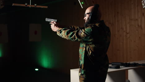 portrait of happy soldier in firing range preparing for mission with weapon