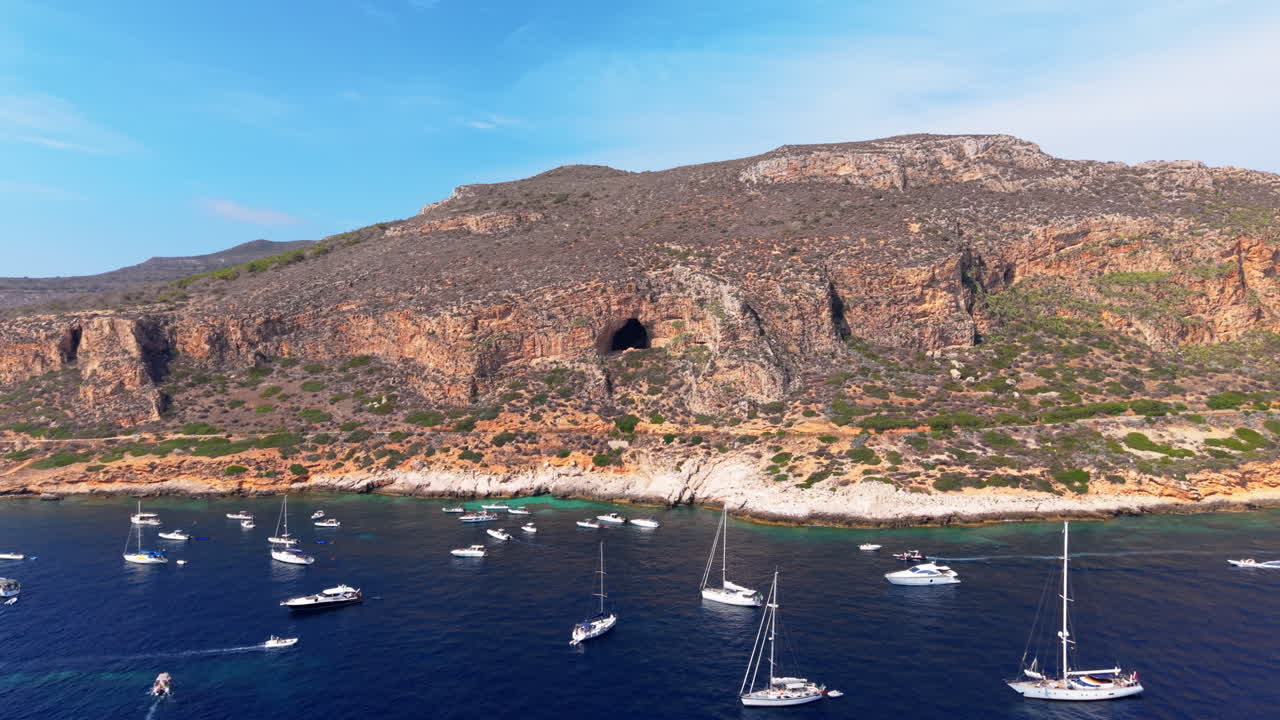 Aerial view of a bay with boats and a mountain