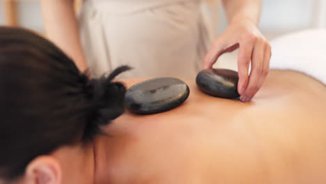 hands, massage therapist or hot stone in spa