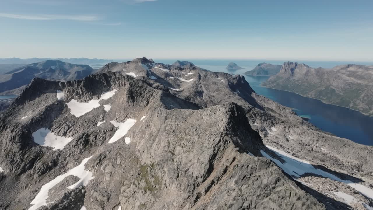 FPV drone soars above Northern Norway's majestic fjords, amidst steep mountains, showcasing the awe-inspiring beauty of this Arctic wonderland