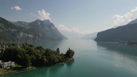 beautiful view from drone flying over weesen town based near shore of walensee lake, switzerland with blue sky