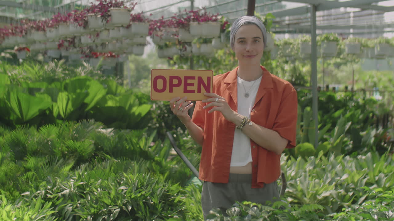 Portrait of Senior Plant Nursery Worker with Open Sign