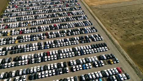 Aerial-footage-of-finished-cars-ready-to-be-shipped-on-huge-distribution-center