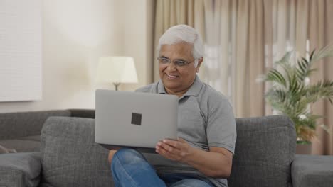 Happy-Indian-old-man-working-on-laptop