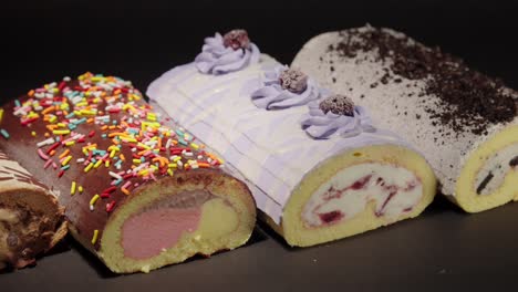 slider shot of ice cream froster swiss cake rolls collection with black background oreo blackberry neapolitan mix with sprinkles and mocca mocha flavors