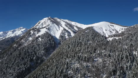 air flight through mountain clouds over beautiful snow-capped peaks of mountains and glaciers.