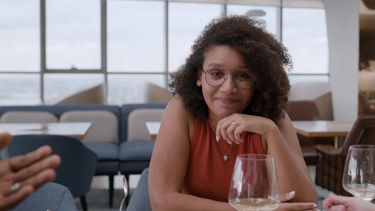 Friends Having Lunch at a Restaurant with City View