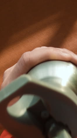 hand holding a metal water bottle with a grey lid