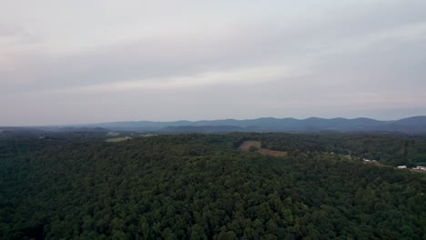 drone shot footage of a sunset over a mountain in an overcast sky