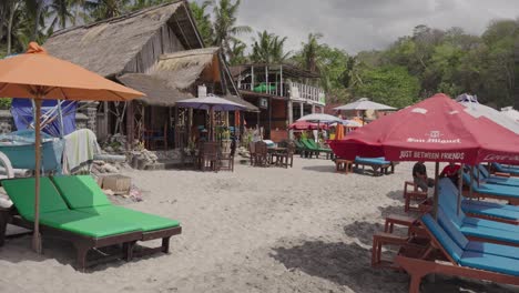 Empty-sunbeds-in-Bali-famous-Virgin-Beach,-holiday-destination,-tourism