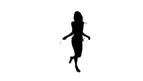 silhouette of a woman using a skipping rope