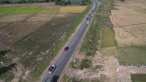 Aerial-Drone-Footage-Of-Red-Car-Moving-On-The-Highway