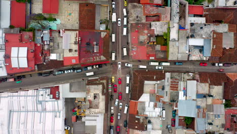 Downward-angle-drone-shot-of-San-Cristobal-de-las-Casas-Mexico,-traffic,-streets-and-buildings