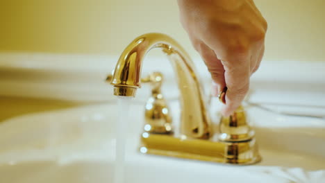 open a tap with water in a luxurious bathtub