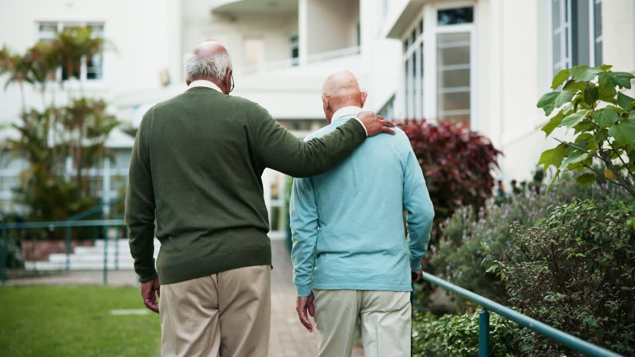 Elderly men walking together in a garden