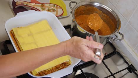 preparing lasagna, a typical italian pasta course