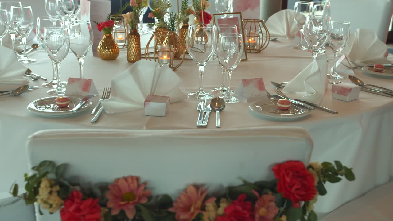 Wedding table decorated with flowers and shinning tableware, motion shot