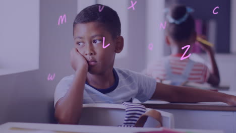 animation of letters over bored biracial schoolboy at desk in classroom