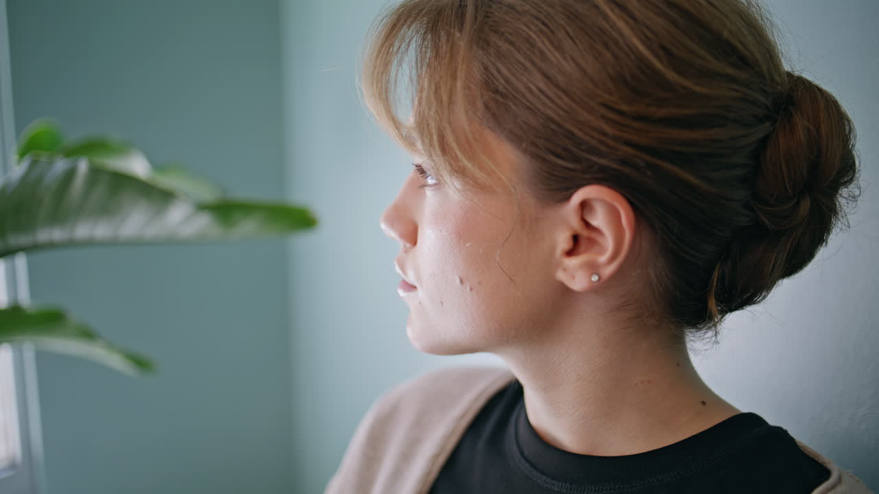 Closeup young woman sitting waiting room modern office. Portrait of girl patient