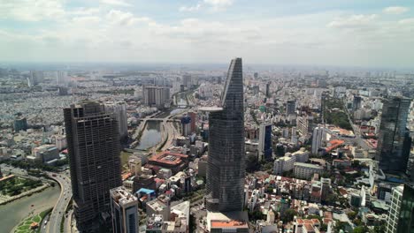 dolly left aerial cityscape of buildings in saigon vietnam on a sunny day