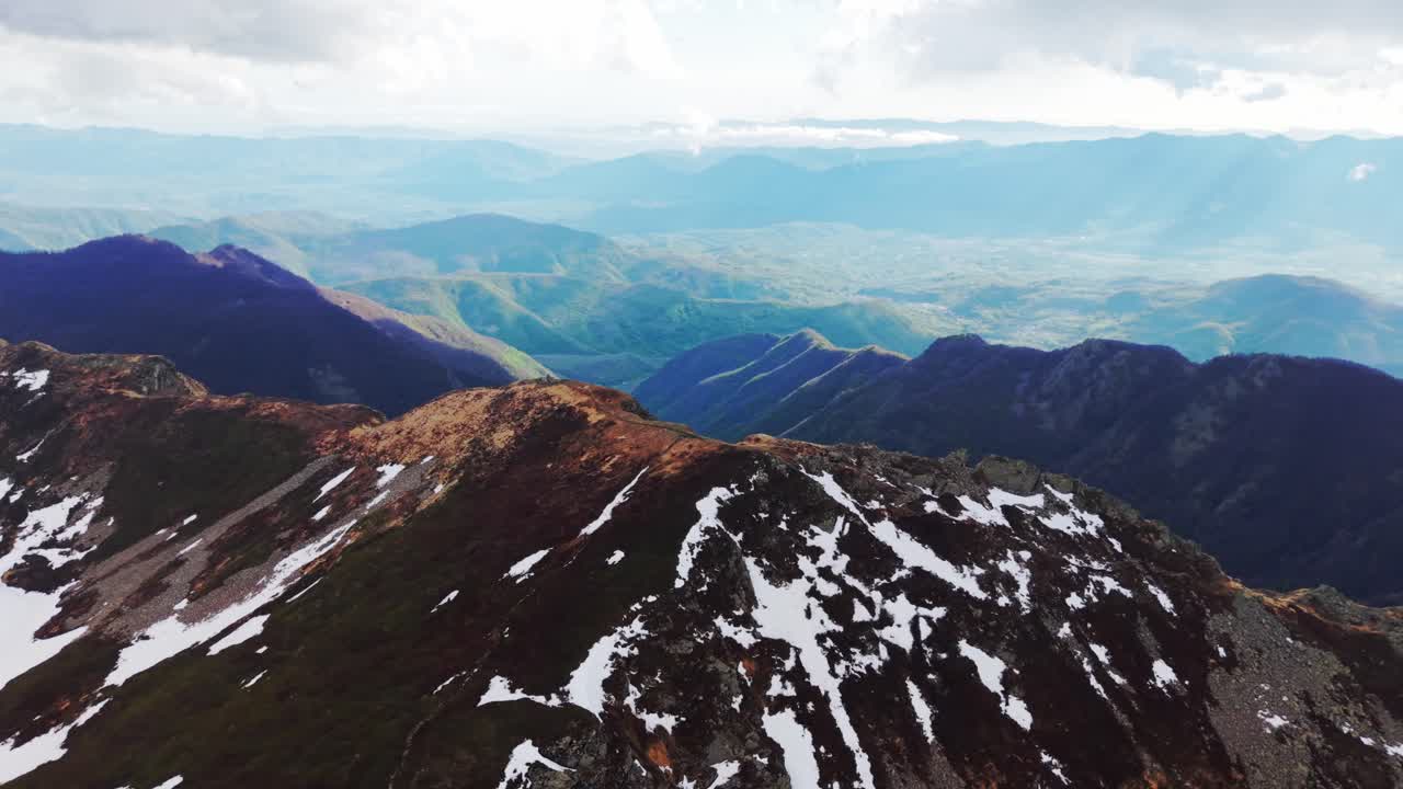 Stunning view over the Dolomites with sweeping mountains and light shining through clouds
