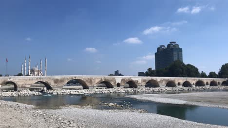 sunrising timelapse of stone bridge (taskopru) and sabanci central mosque in adana, turkey