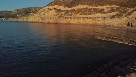 Sunrise-at-Port-Ginesta-with-stone-jetty-and-calm-waters-in-Barcelona