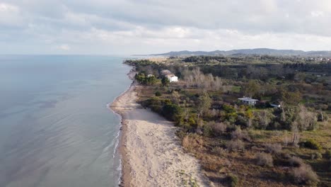 dramatic aerial view flight fly backwards drone footage of golden sand bouka beach at corfu