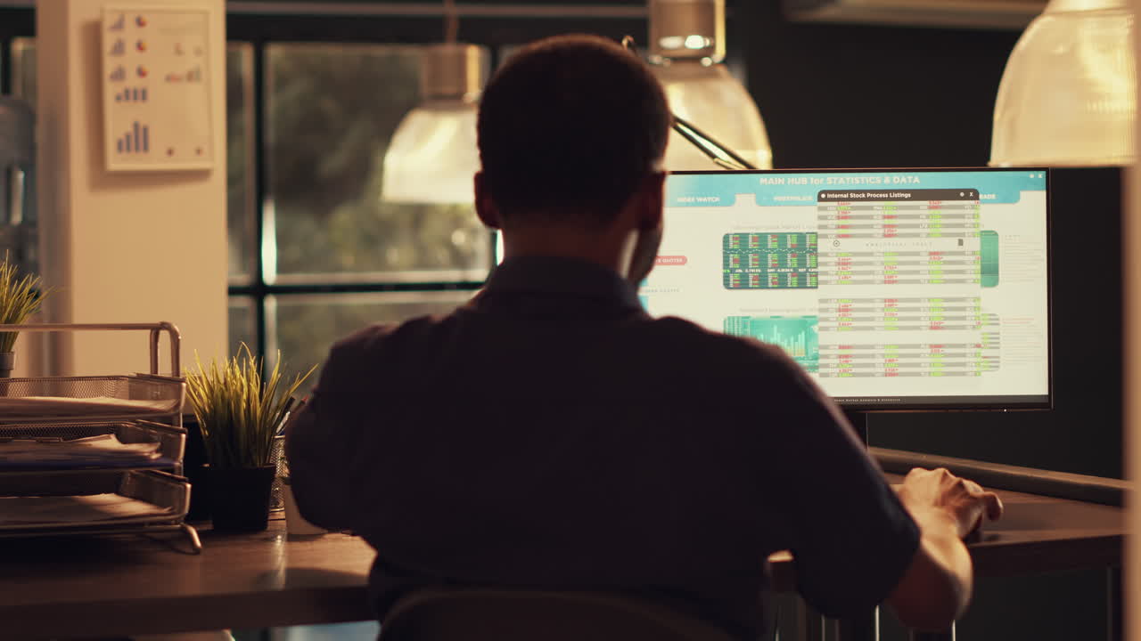 Financial broker looking at stock market statistics on computer