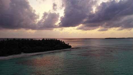 heavy dark clouds and dramatic sunrise over the island and calm sea