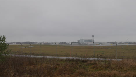 slow wide pan of the arlanda airport on a cloudy and rainy day in stockholm