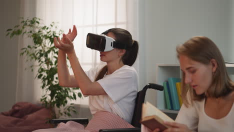 disabled woman in vr glasses plays game while sister reading