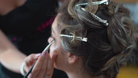 bride with hair clips being make up